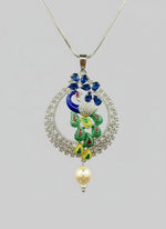A rhodium-silver plated peacock design pendant with silver chain ,featuring vibrant green, blue, enamel accents, as well as sparkling crystal white and bottle green AD stones. Pendant with silver chain design is focused. 