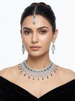 Intricate design silver finish choker set with emerald green round and teardrop stones – Indian/Pakistani wedding wear.