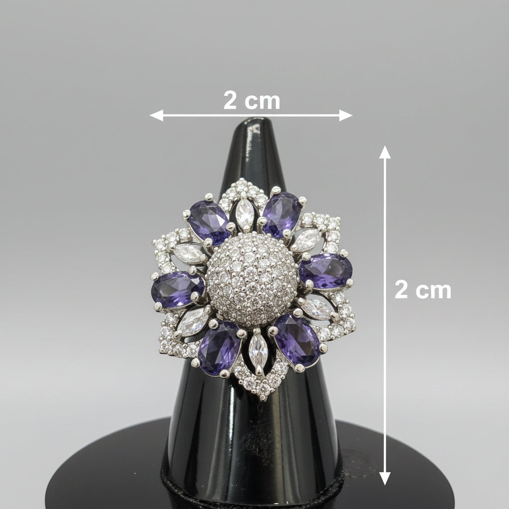 Silver-tone floral halo ring with oval purple stones, round American diamond center, and marquise clear accents.
