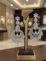 pair of sophisticated silver-toned statement earrings with intricate floral