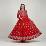 Red dress with white floral patterns on a decorative background