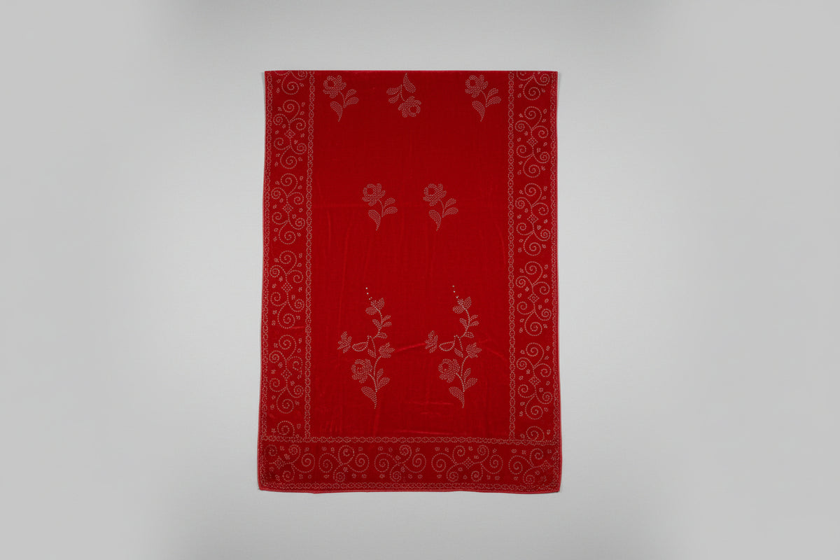 Red fabric with floral patterns on a gray background