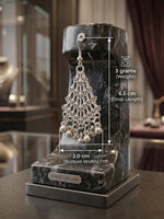 A silver dangling earring displayed on a black marble stand with overlaid measurement labels showing 6.5 cm drop length, 2.