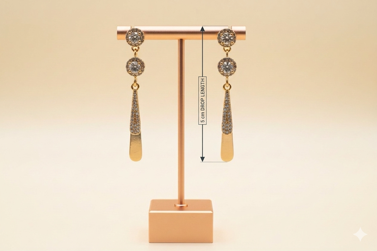 Rose Gold earrings with AD white stones on a stand with measurement label against a beige background