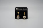Rose Gold earrings with clear gemstones displayed on a posh earrings stand with pure white background. 