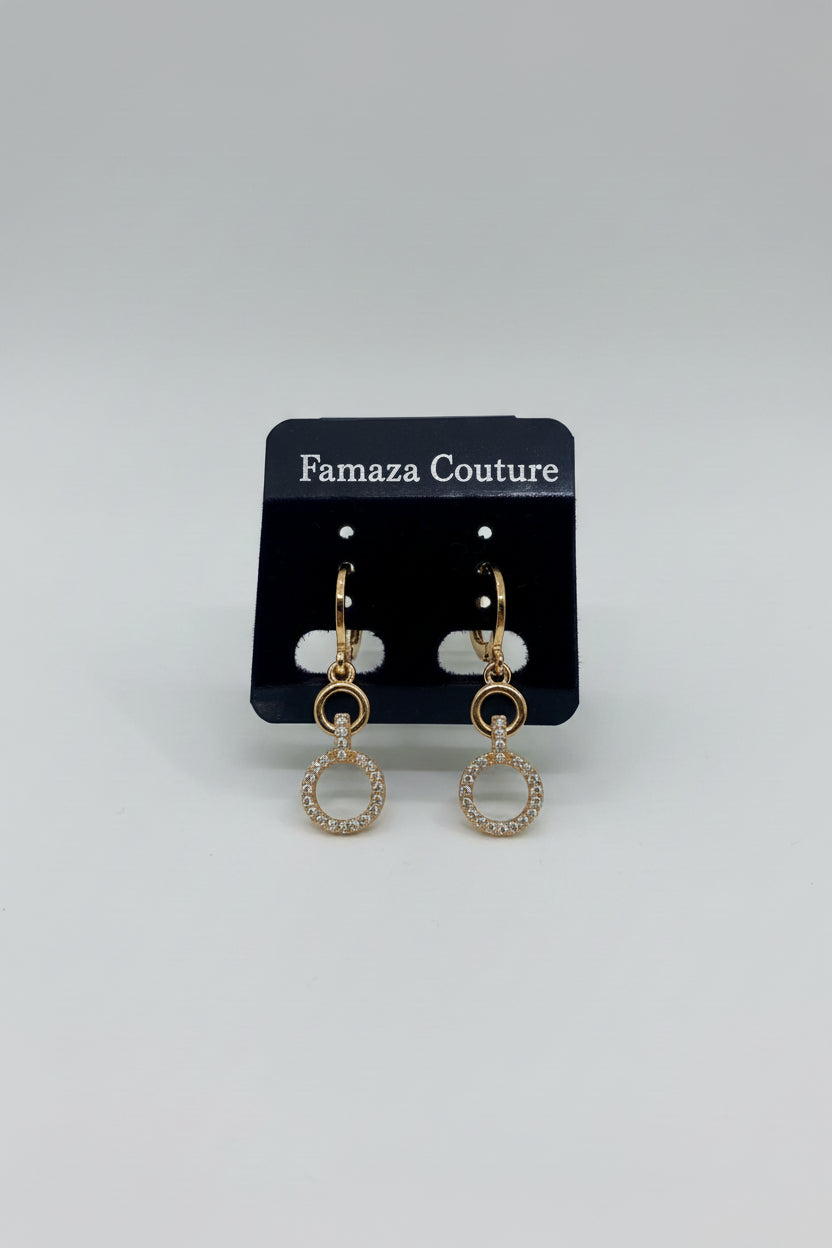 Rose Gold hoop earrings on a black earring card with visible brand name,Famaza Couture placed on a textured white surface.