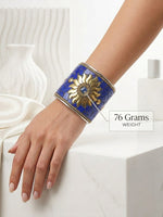Handcrafted wide statement cuff jewelry weighing 76g, showcasing vibrant blue mosaic tiles and an antique brass-toned sun setting.