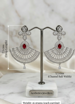 Beautiful model with an elegant low bun showcasing a luxury silver and ruby red American Diamond fan-shaped chandelier earring paired with a classic black off-the-shoulder velvet top.
