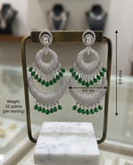 Royal Emerald Dual Moon grand American Diamond chandelier drops on a luxury jewelry stand