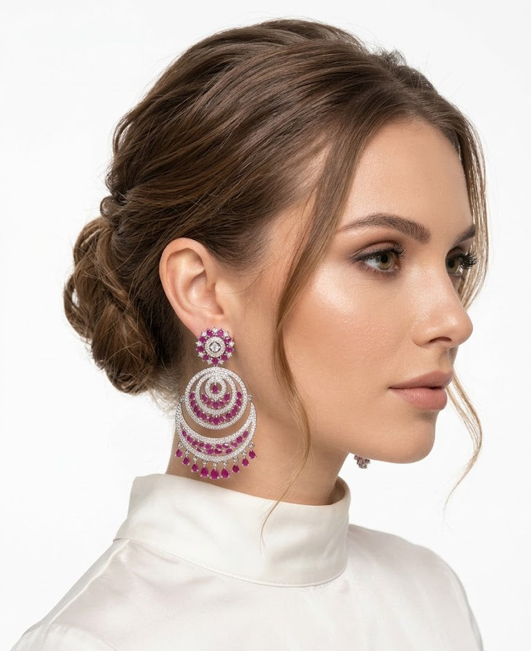 Elegant model wearing Royal Fuchsia Crescent Statement Dangle Earrings featuring vibrant pink stones in a chandbali-inspired silver setting.