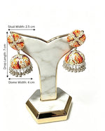 A product dimensions photograph of the Kalamkari art-printed jhumka earrings displayed on a white marble and gold-trimmed stand against a plain background, featuring overlaid text and arrows indicating a drop length of 7 cm, dome width of 4 cm, and stud width of 2.5 cm.