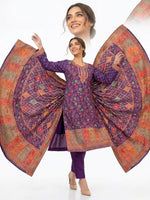 A model poses against a pure white background wearing a deep purple Kanni embroidery silk kurta set, featuring intricate patterns and zari work, paired with a matching dupatta and raw silk trousers.
