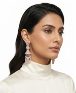 A pair of luxury rose gold multi-tier Jhumka chandelier earrings displayed on a matching rose gold T-bar stand, featuring an emerald-cut crystal top stud, a marquise floral star link, a micro-pave dome, and a lower teardrop lattice medallion.