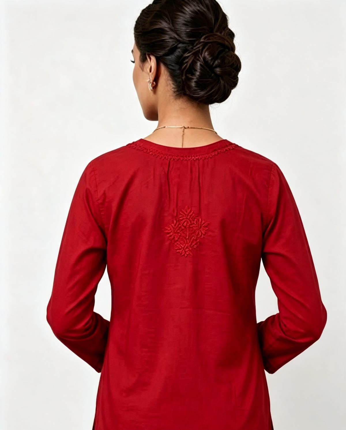 Back view of the vibrant red short kurti showing a detailed embroidered motif on the upper back, presented as an individual short kurti without bottom trousers.