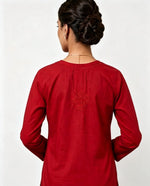 Back view of the vibrant red short kurti showing a detailed embroidered motif on the upper back, presented as an individual short kurti without bottom trousers.