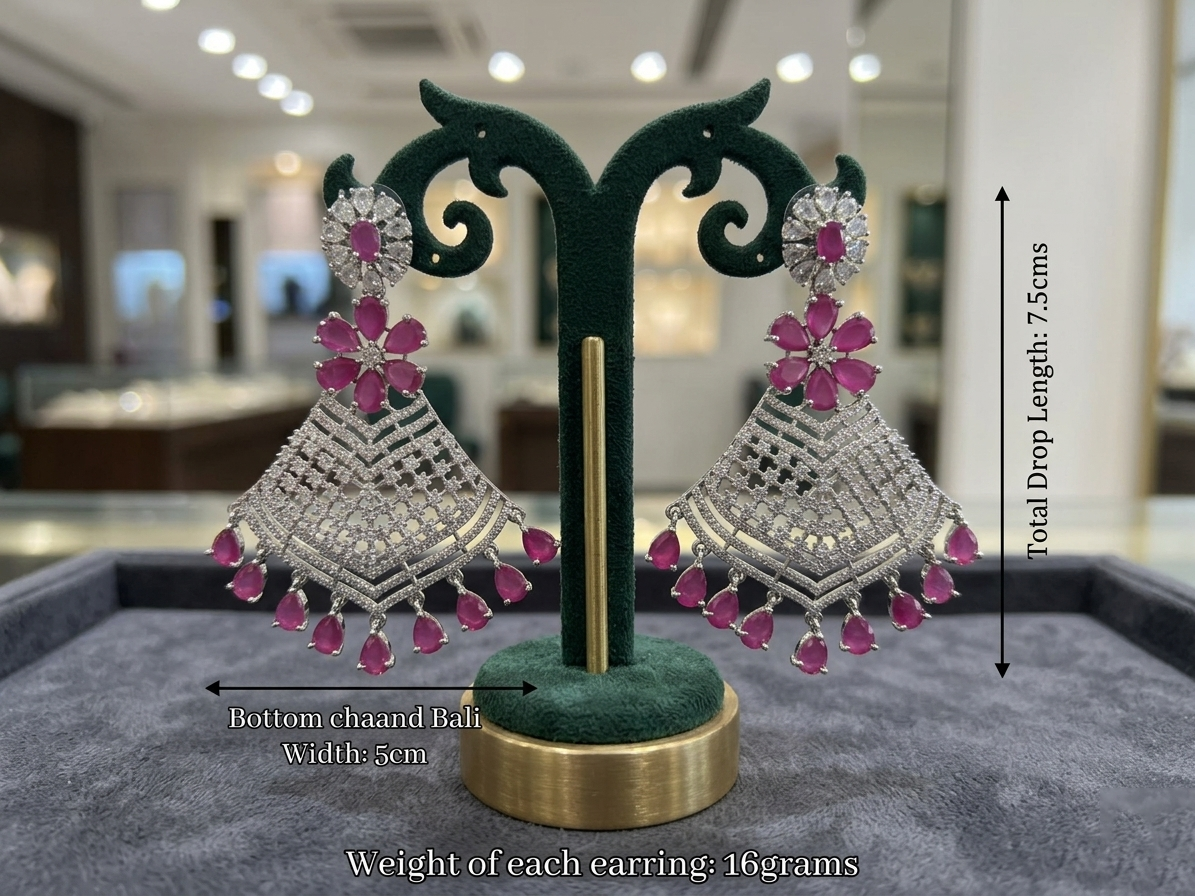 Pair of silver and pink earrings on a green stand with measurements and weight details.