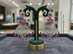 Pair of silver and pink earrings on a green stand with measurements and weight details.