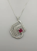 Ruby pink centre stone pendant, featuring a geometric design with intricate detailing, displayed on a black mannequin. Party wear set.