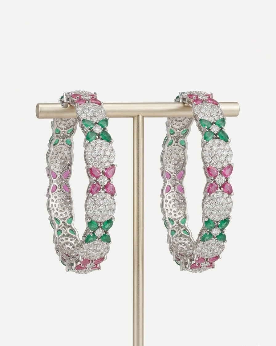 Pair of silver-tone scalloped bangles with pavé-set American Diamonds displayed on a gold T-bar stand.