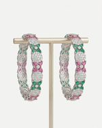 Pair of silver-tone scalloped bangles with pavé-set American Diamonds displayed on a gold T-bar stand.