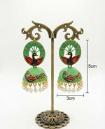 Seagreen 5.5cm hand-painted peacock jhumka earrings on a professional stand showing the 3cm width.