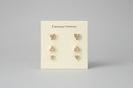  Set of three pairs of minimalist geometric triangle crystal stud earrings on A.P. Jewellery display card.