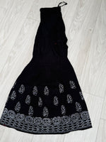 Sharara with white thread bakhiya embroidery is shown as folded in double layer. Focus is embriodery.