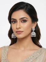 Model wearing silver American diamond jhumka earrings – real-life scale on ear