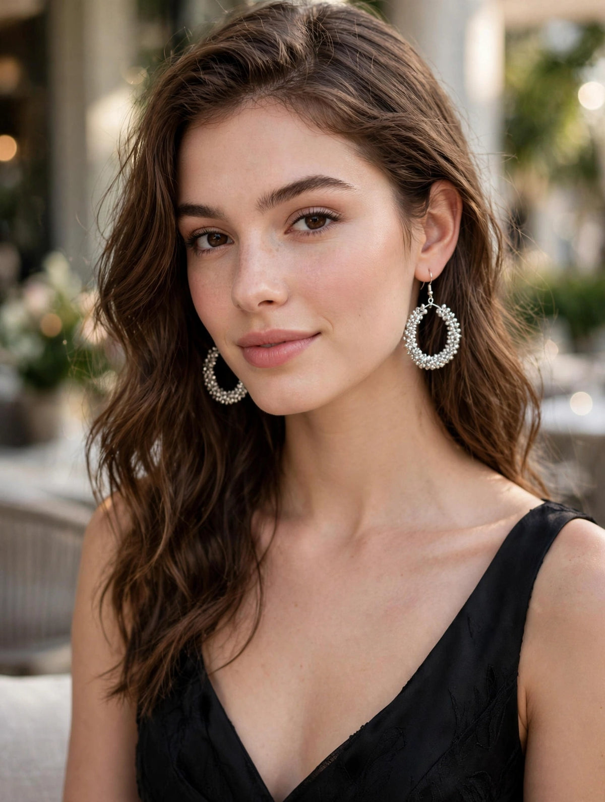 Model wearing silver crystal-encrusted teardrop hoop earrings with fishhook closure — Famaza Couture bridal & festive luxury jewelry.