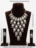 Antique silver Y-shaped statement choker necklace set with mirror accents, 16cm width, 25cm drop, matching jhumka earrings 5.5cm drop — displayed on brown velvet bust.