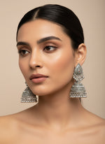 Model wearing silver oxidised leaf drop earrings