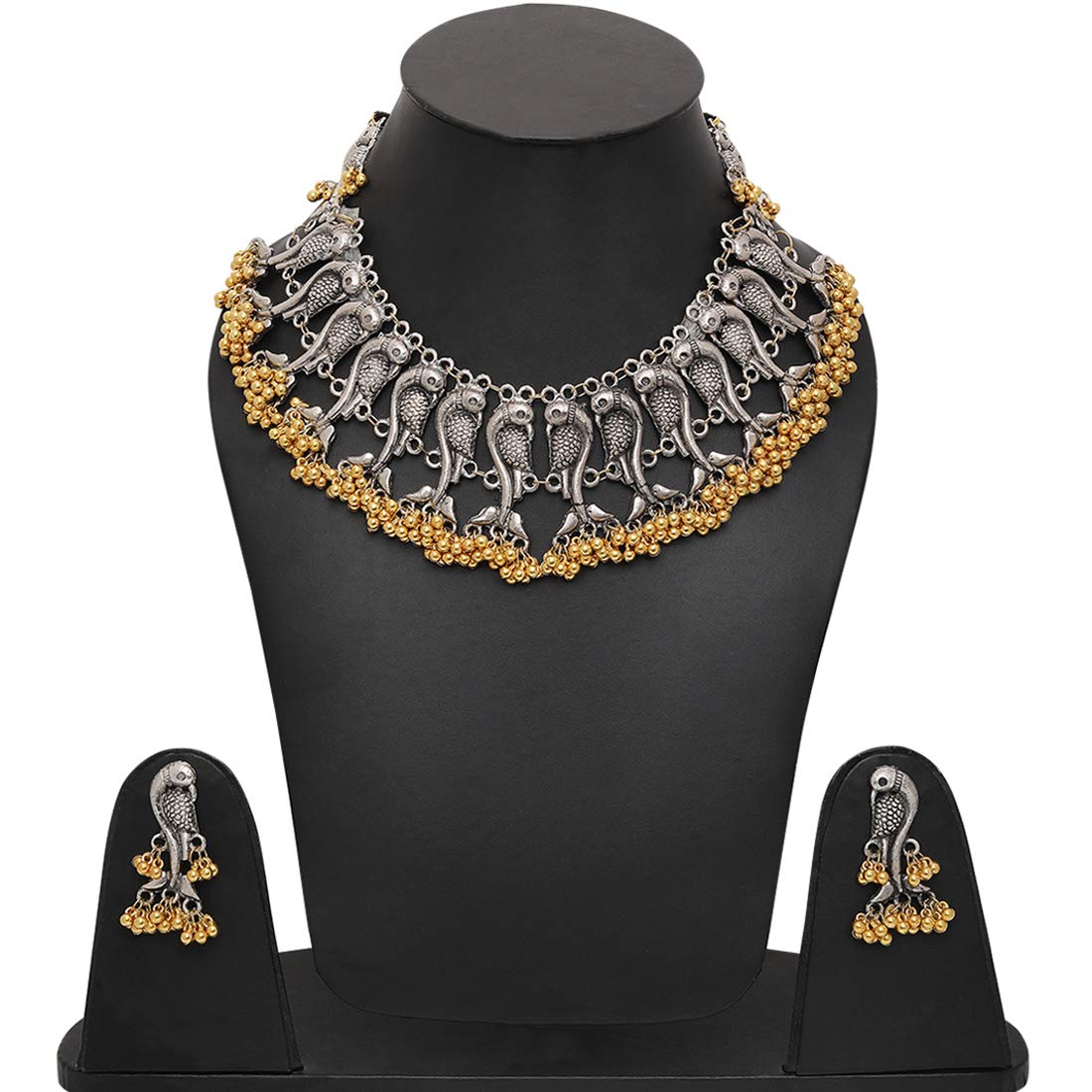 Silver and gold statement necklace with matching earrings displayed on a black mannequin bust and stand against a white background.