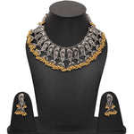 Silver and gold statement necklace with matching earrings displayed on a black mannequin bust and stand against a white background.