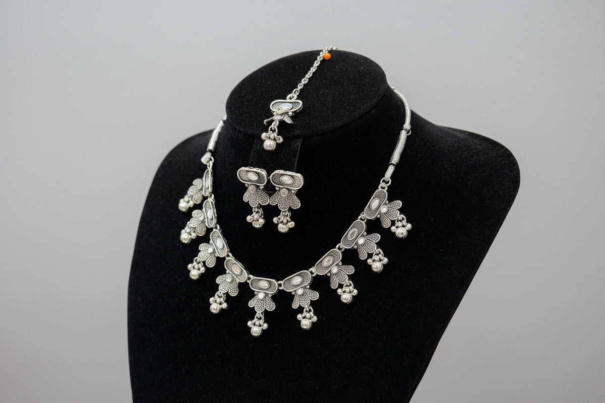 Silver jewellery set with choker necklace, earrings and maang tikka 