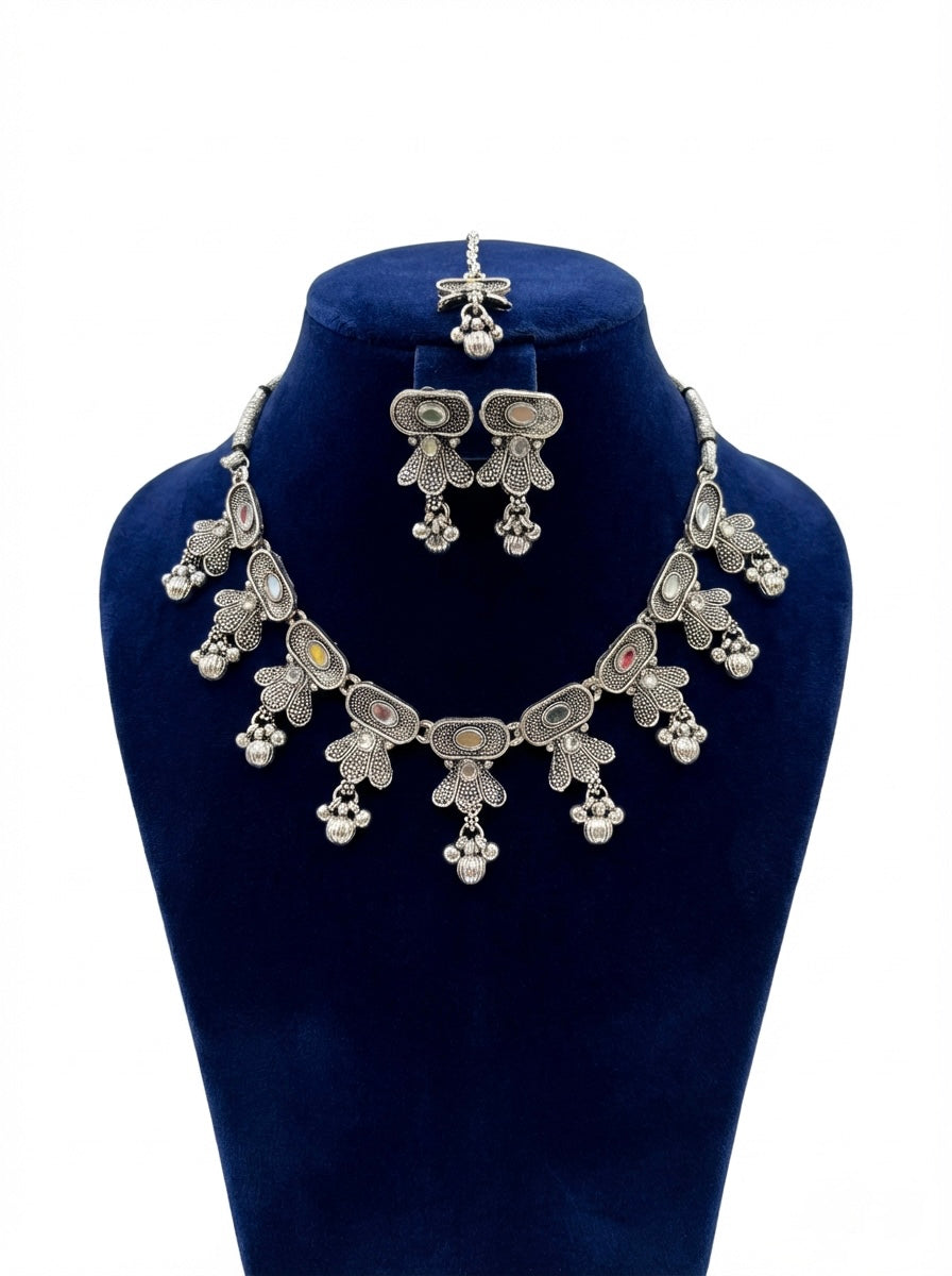 Silver jewelry set with necklace and earrings on a blue mannequin bust.