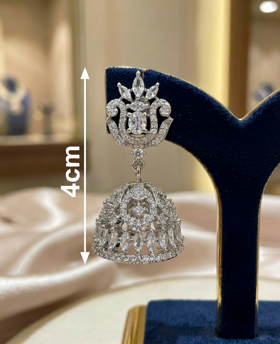 Silver jhumka earring on a stand with measurements