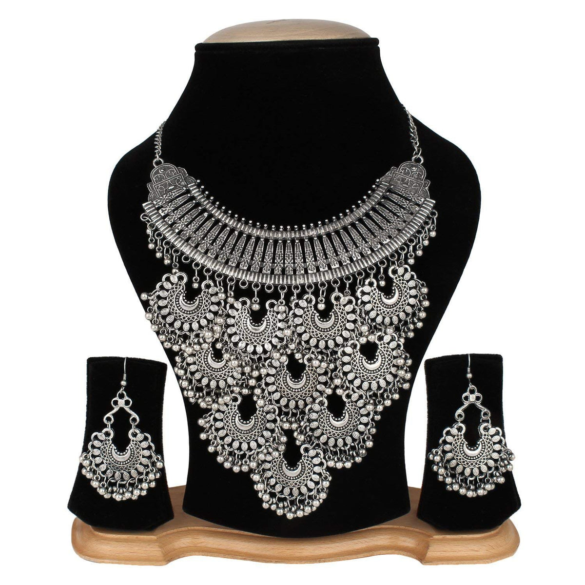 Silver necklace and earrings set on a black mannequin bust with a white background