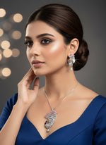 Silver plated a set of peacock-shaped pendant in silver chain with peacock-shaped earrings. The pendant is detailed with blue enamel and has sparkling crystal pink and white AD stones embellishments.