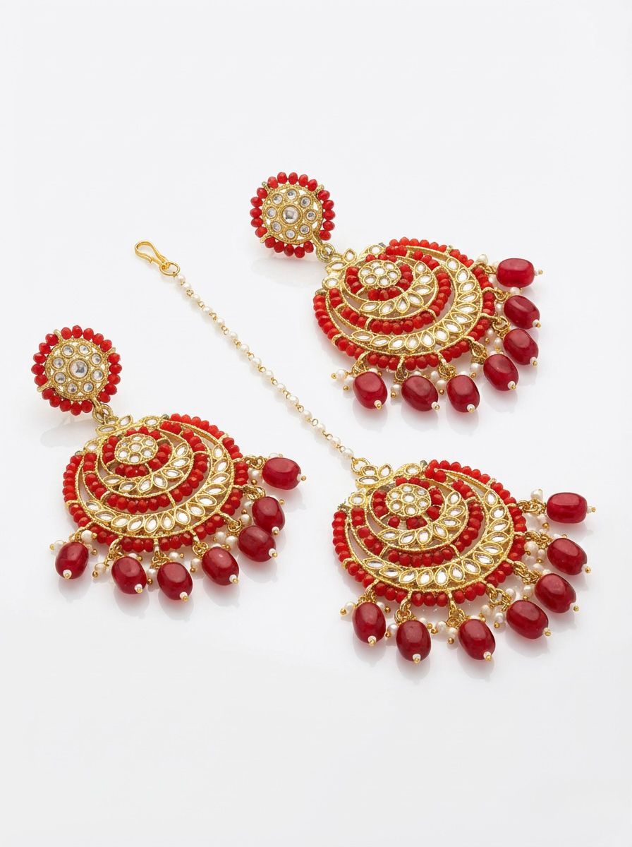 Sophisticated red and rose gold statement jewelry set against a traditional bridal ensemble.
