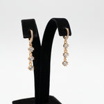 Stylish dangling crystal earrings with a 3.5cm drop length, featuring high-shine gold-tone finish and sparkling square accents.