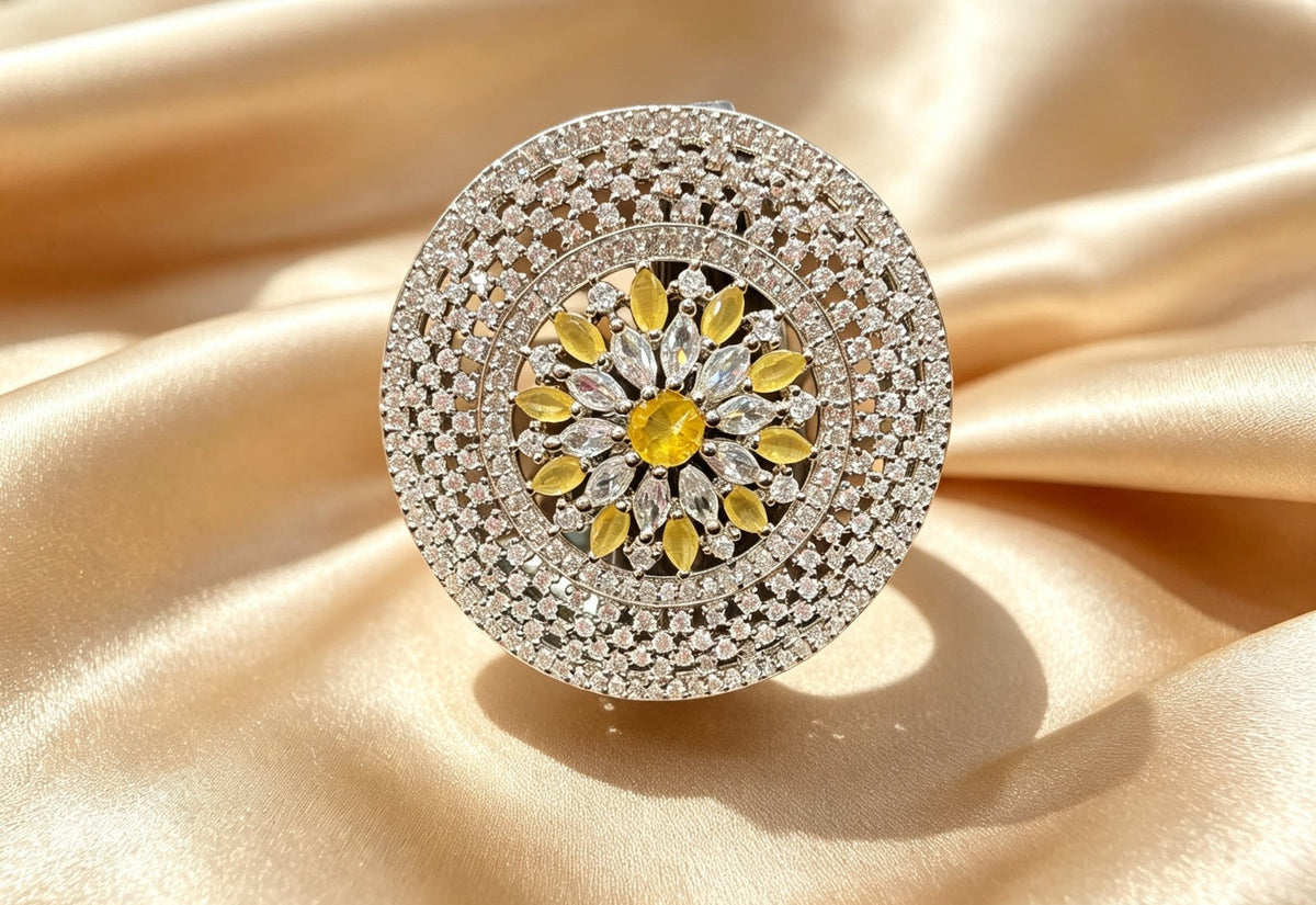 Sunflower Splendor Diamond Statement Ring by Famaza Couture — Fancy Yellow center stone with marquise and pear-cut white diamonds, displayed on champagne gold satin, luxury floral halo cocktail ring.