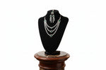 The AD triple layer cubic zirconia and emerald green centre stones necklace, earrings and maang tikka .