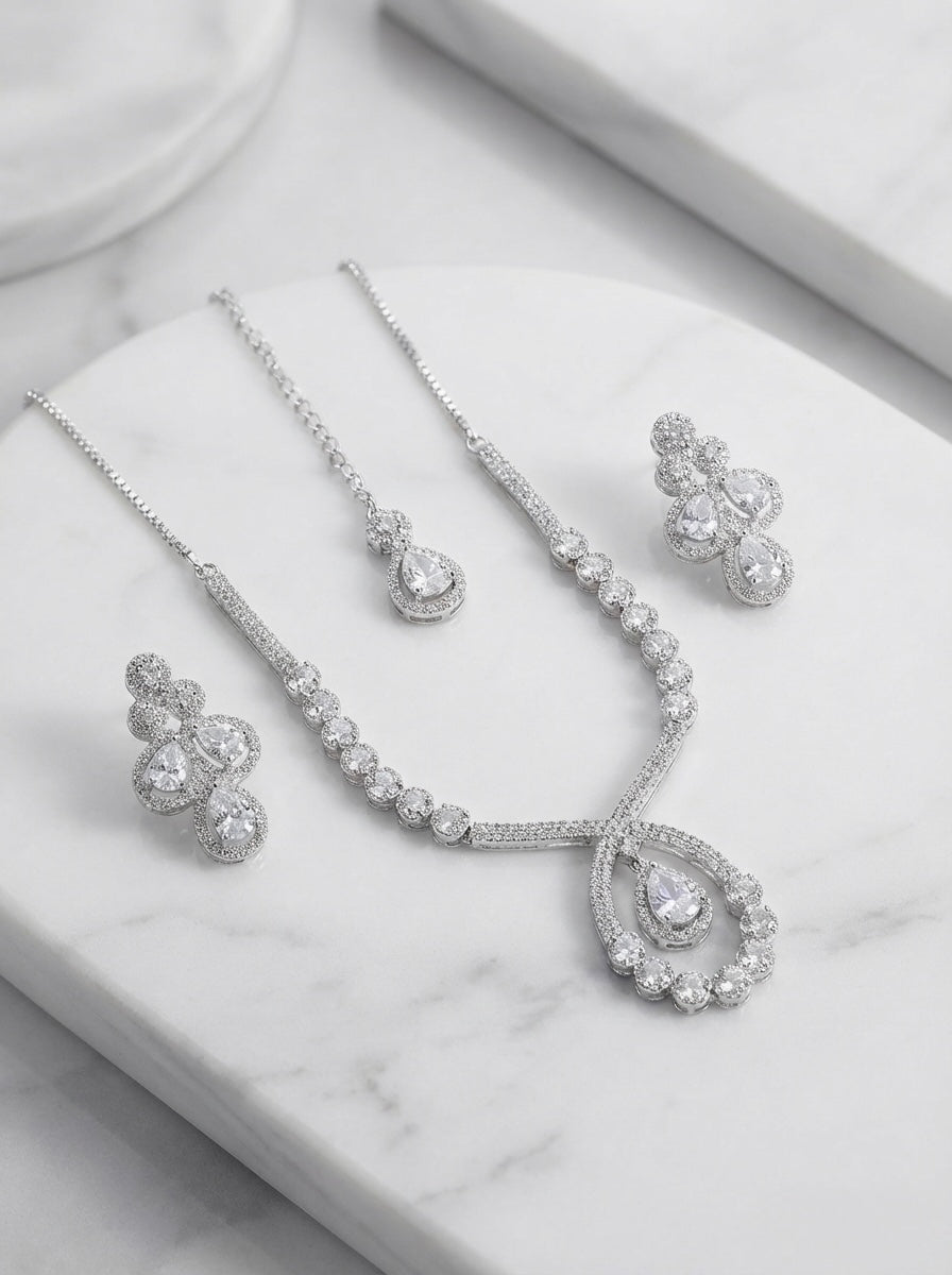  The American diamonds bridal jewellery set including necklace, earrings and maang tikka.