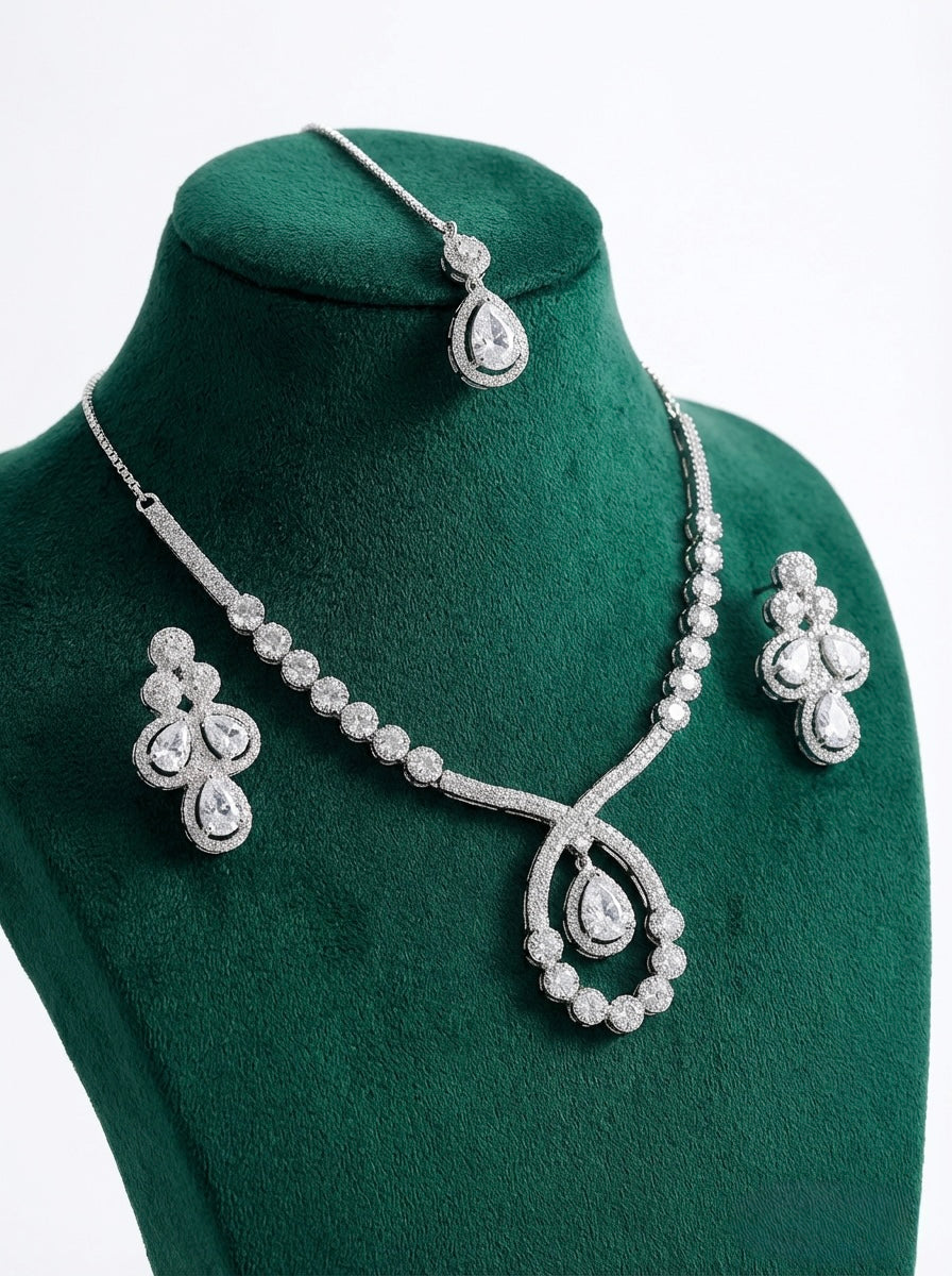 The American diamonds bridal jewellery set including necklace, earrings and maang tikka is displayed on the dummy. 