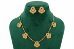 The Antique gold brass metal necklace and stud earrings with ruby red central stones. 