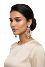 A pair of luxury statement chaand bali chandelier earrings in rose gold, featuring brilliant clear American Diamonds in a floral sunburst design with hanging blush pink teardrop gemstones 