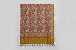 The Kashmiri embroidered pashmina scarf in mustard yellow with floral patterns and tassels on the ends.