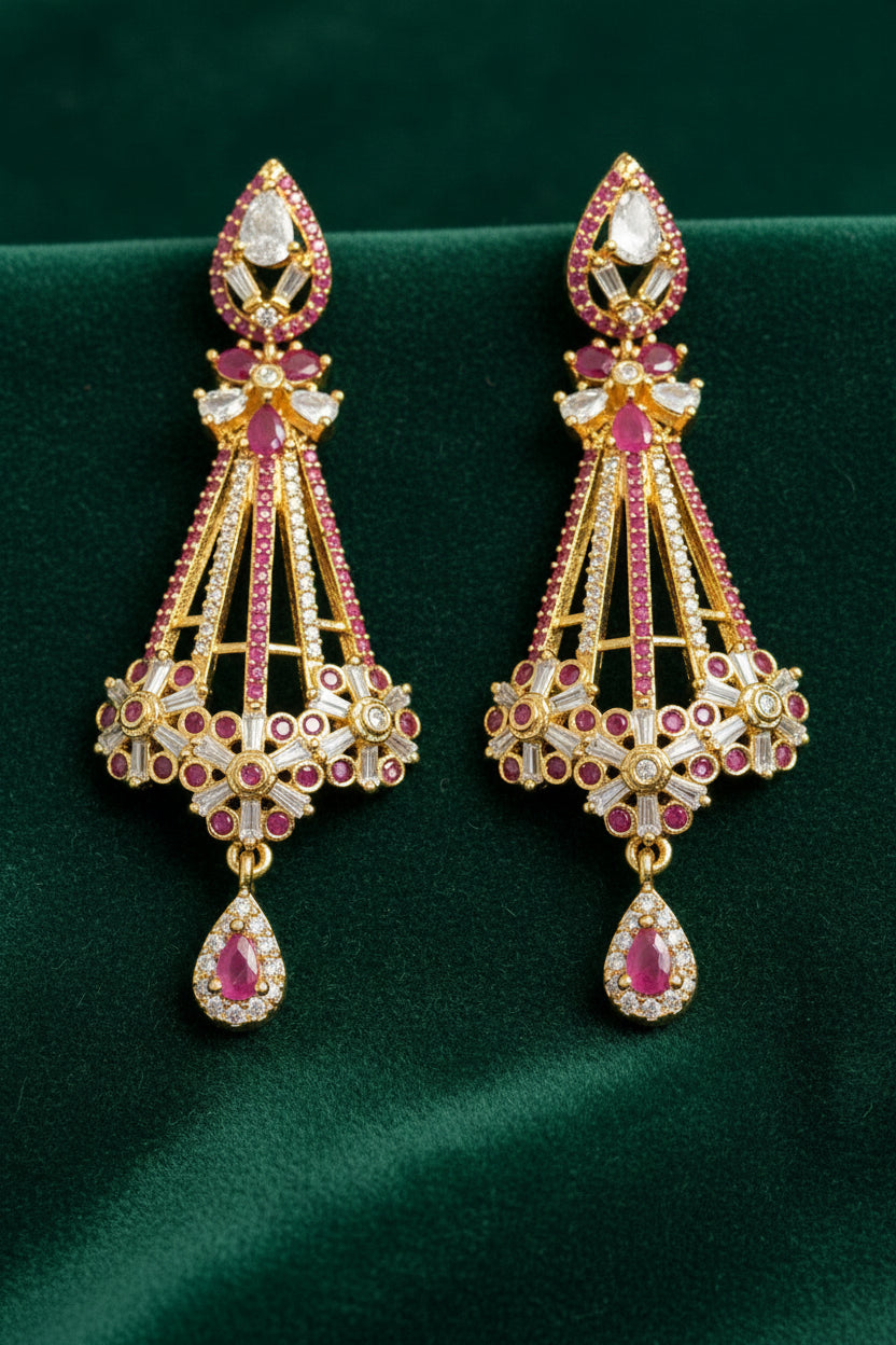 The Luxury gold chandelier drop earrings featuring red ruby gemstones and cubic zirconia accents, presented in a two-panel product display.