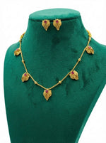 The Minakari Red stone necklace displayed on professional jewellery stands.