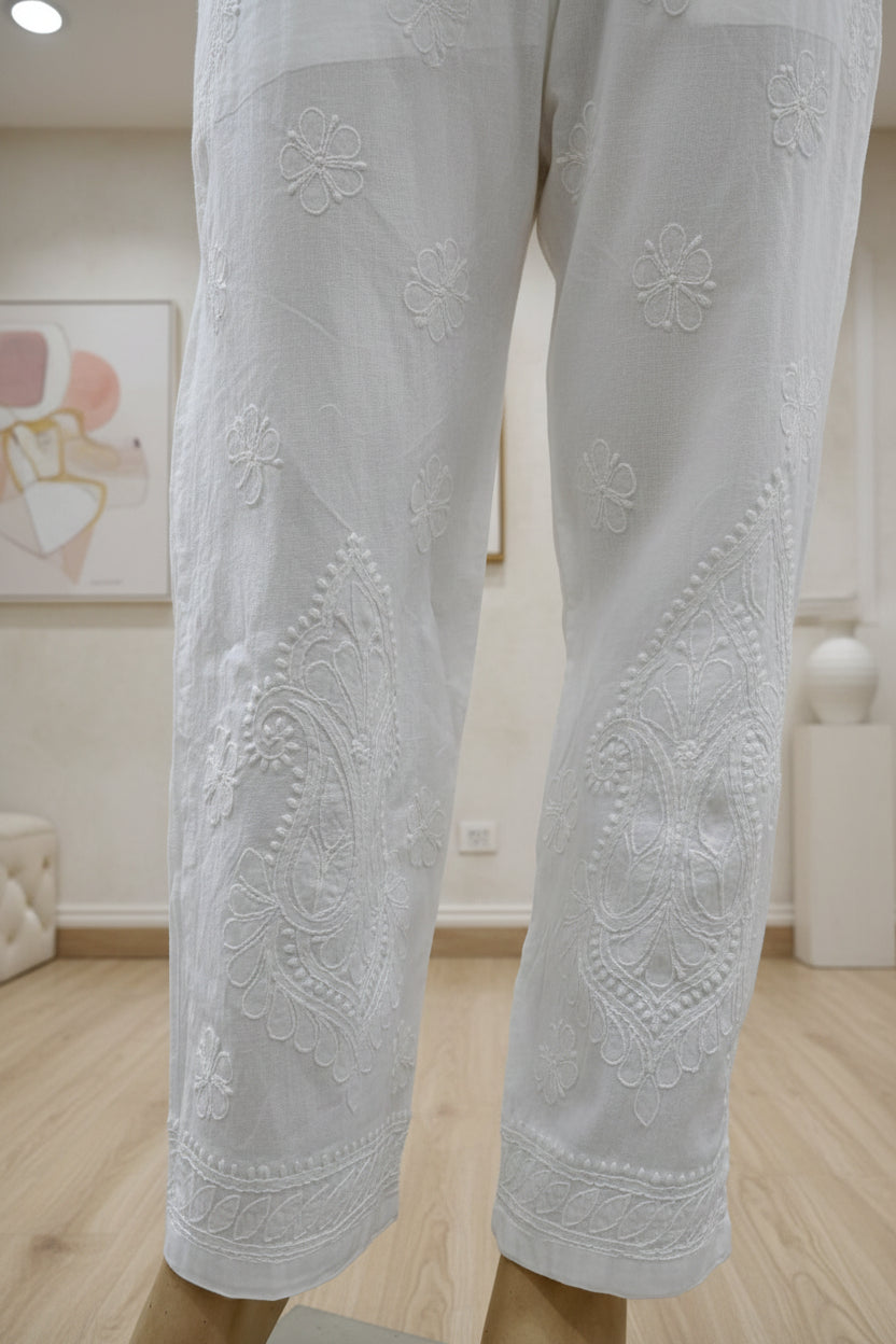 The White stretchable cotton hand embroidered chikankari pants with pockets.